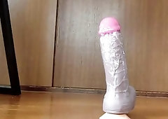 Crossdressing shemale rides a dildo and shoots loads of jizz