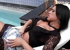 Brunette shemale toys her ass and masturbates by the pool