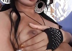 Ebony transsexual in fishnet stockings uses a cold sextoy