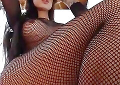 Bombastic shemale in fishnet bodystocking teases with her big tits