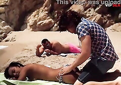 Topless Black Sweetheart Oiled Up on the Beach... His Hands Slip Beneath Her Bikini