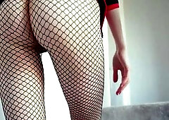 Sexy goth teen posing seductively in fishnet pantyhose