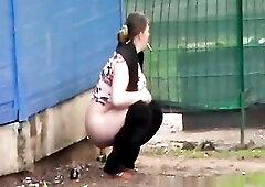 A preggo woman urinates in public