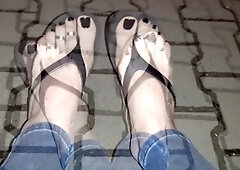 Naughty crossdresser flaunts sexy feet in flip-flops while strolling the streets and seducing admirers