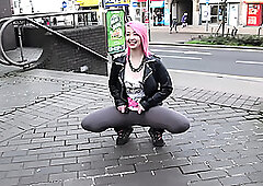 Beautiful and very slutty whore shows her butt in public while pissing between her legs