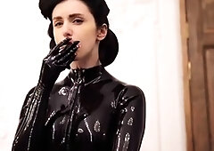 Femdom lady in black latex bodysuit smokes a cigarette