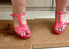 Big legs in open footwear crush and stomp the box with high high-heeled shoes to cod.