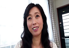 Mature Asian woman enjoys intimate foreplay with a man