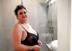 Chubby mature rubs her fat pussy under the warm shower