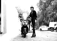 This babe's in a fully fitted latex costume. That babe rides a motorcycle. And shows her enchanting legs to everybody.