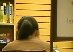 Candid foot fetish moment with a teen girl in the library