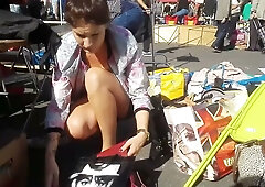 Hidden camera captures women bending and exposing cleavage at outdoor markets