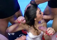 Frida kneels surrounded by masked dudes and deepthroats multiple dongs in turn. This babe gets banged hard whilst jerking off others. Thick loads of c