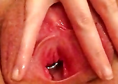 Spreading her cunt out and washing it with some water