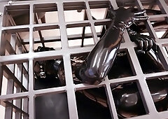 BDSM training session for caged slut in latex bodysuit