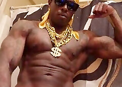 Hallelujah Johnson Jackoff Wearing A Gold Chain, Gold Durag, and Gold Bracelets