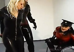 This beautiful Lesbian prisoner is recaptured after trying to escape her sexy captors in shiny latex uniforms so they make sure to restrain her even b