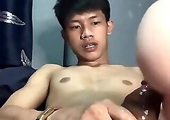 Thai boy jerking off with a toy alone
