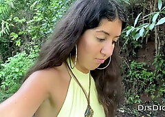 Russian woman bends over a blue motorcycle in a lush forest for a deep throat session
