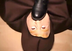 Tattooed brunette in combat boots dominates masked sub with foot trampling